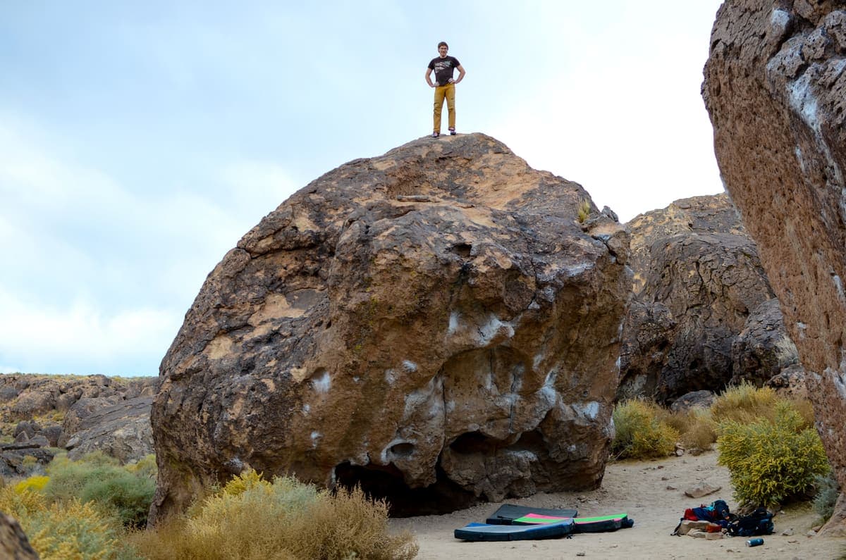 Josh standing on top of a highball boulder