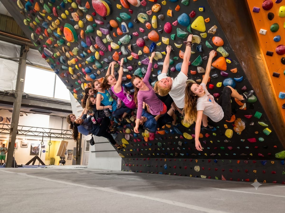 Athletes training on a steep climbing gym wall