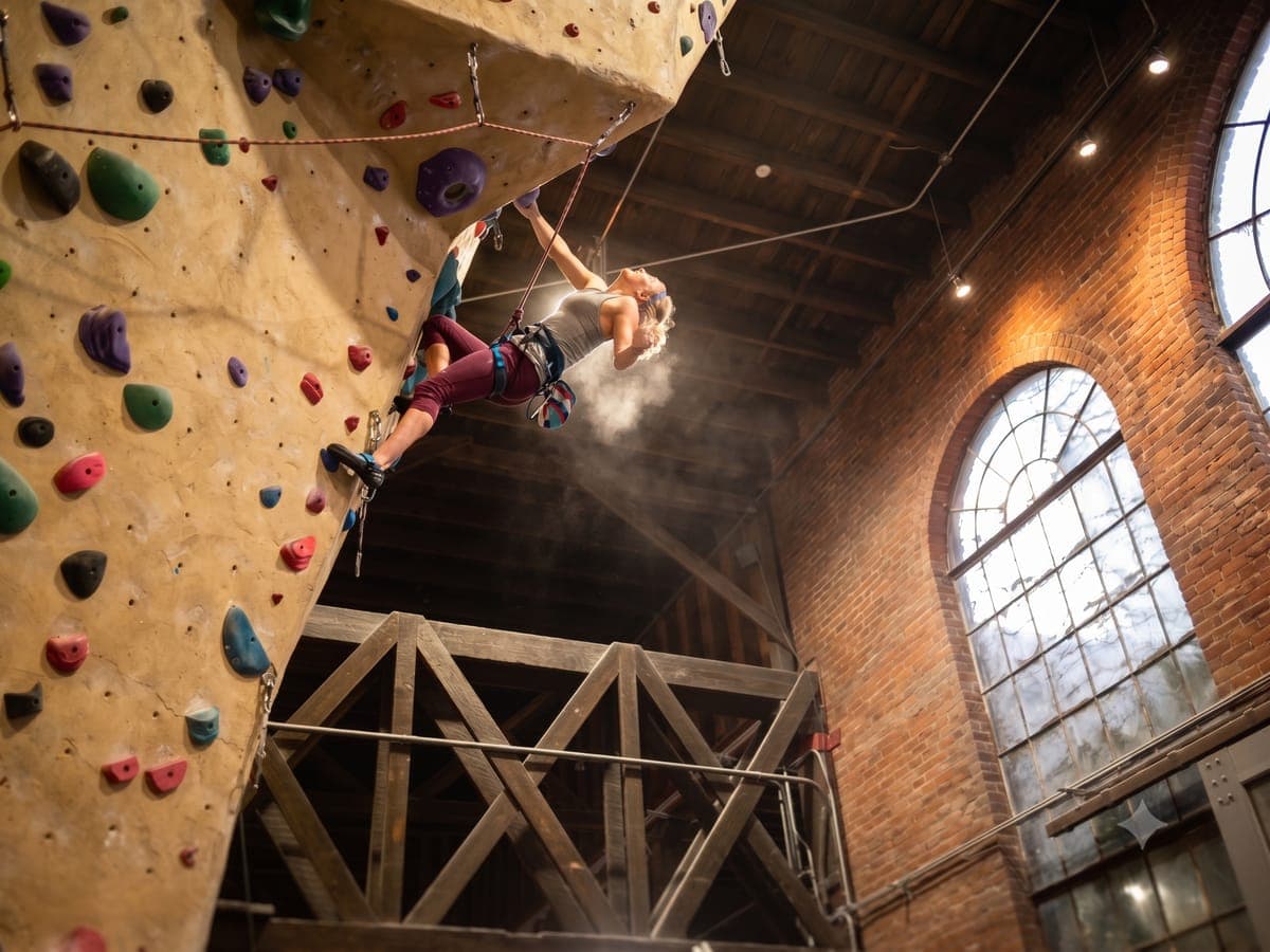 Climber loading upper body on an indoor featured wall